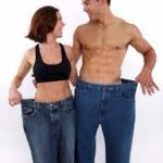 Man and woman with big pants showing weight loss