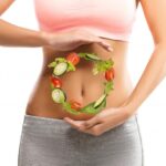 lady with food in hands in front of stomach